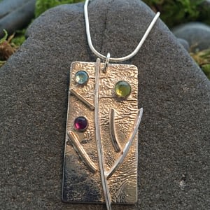 branching out pendant with multiple gemstones